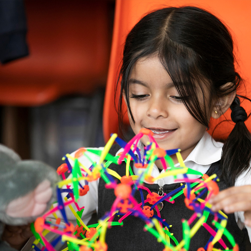 female primary school child with toy