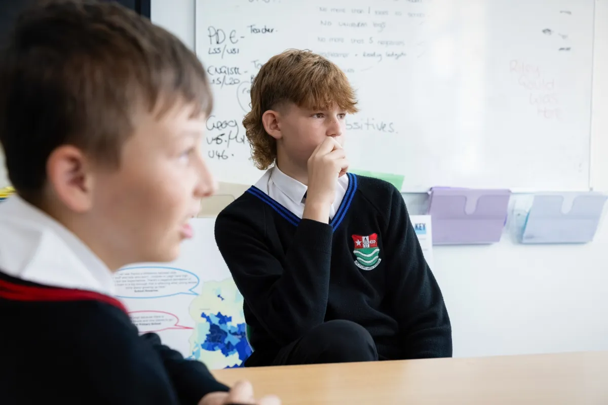 two male secondary children in class