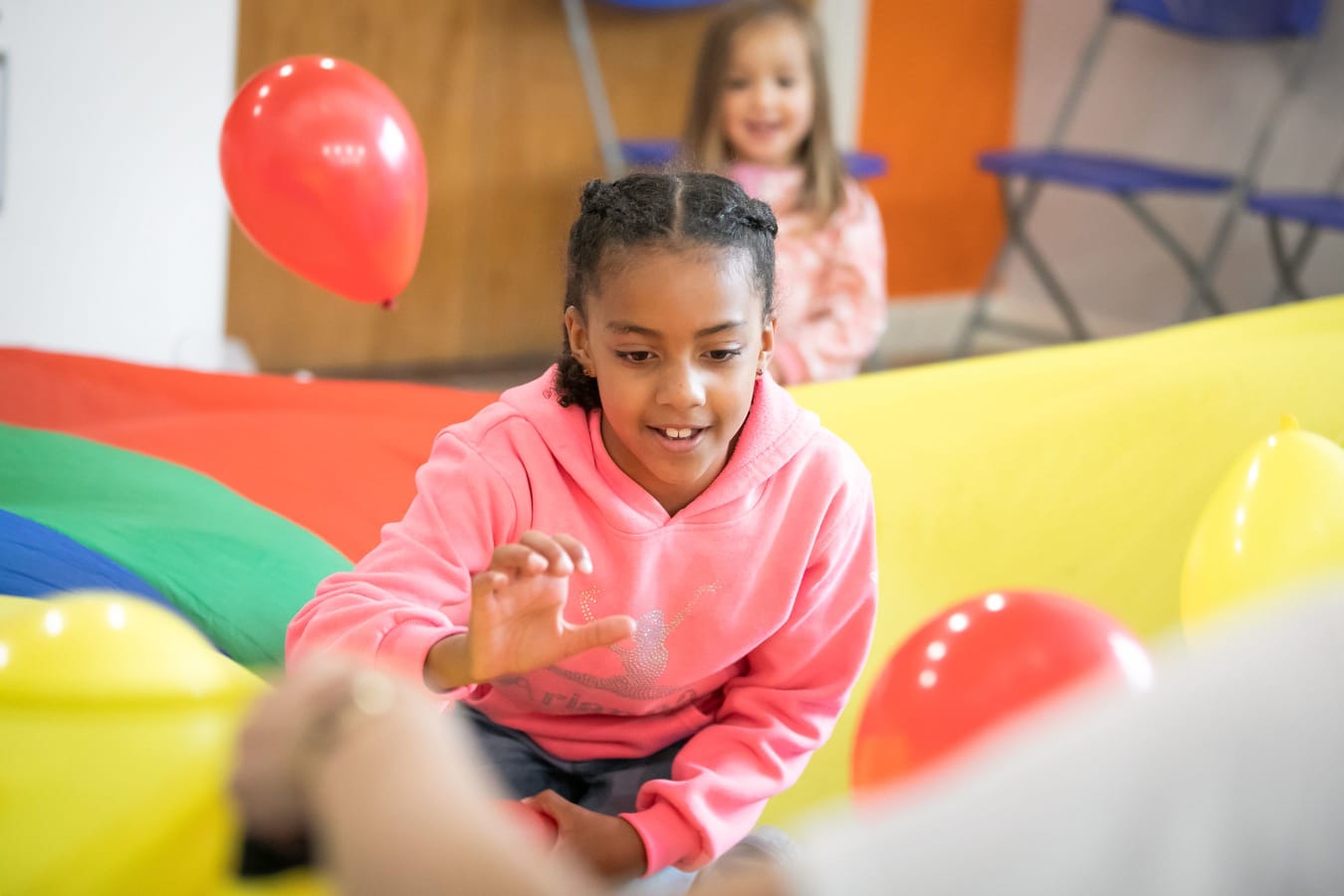 Young girl playing with balloons