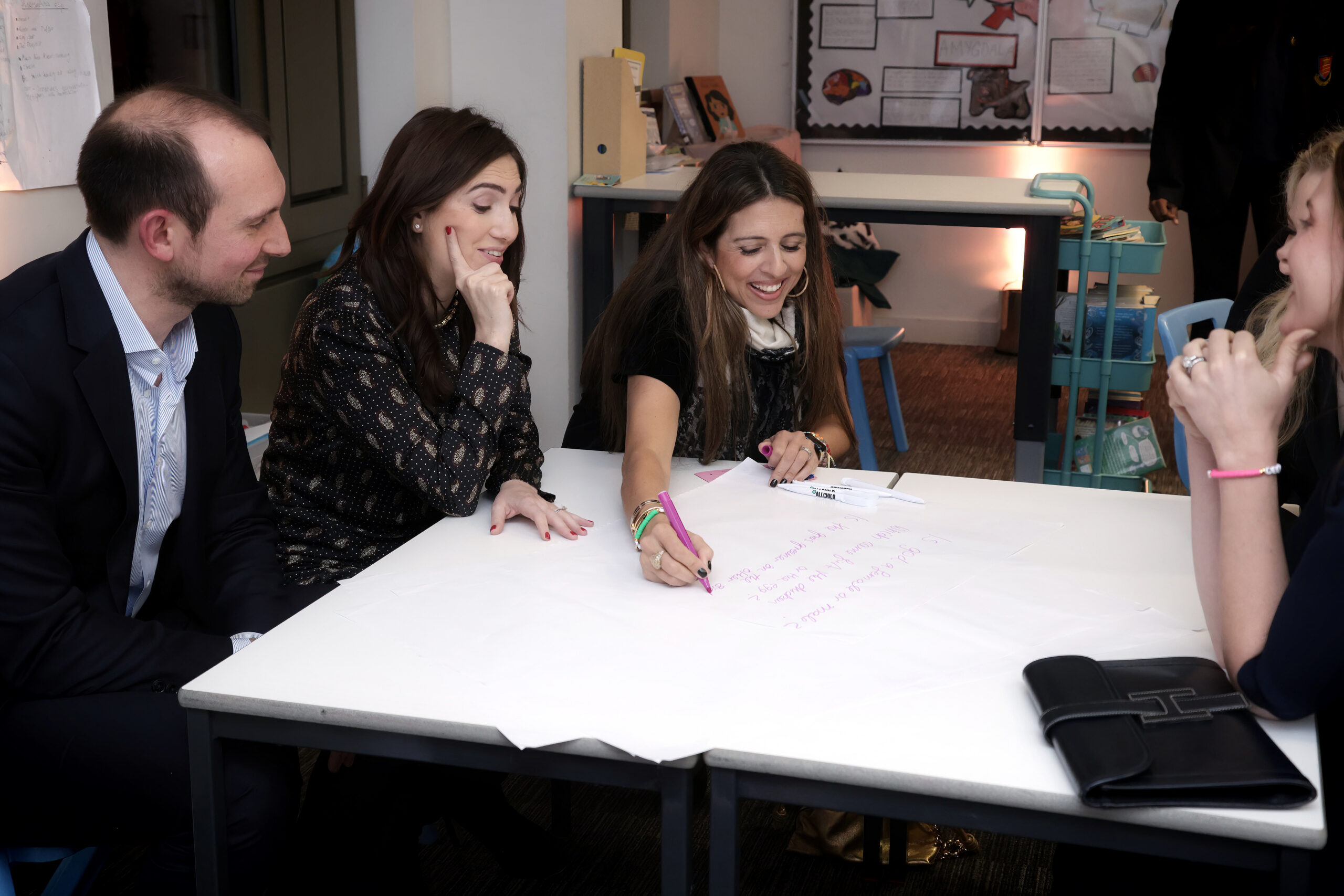 three adults taking part in a school activity