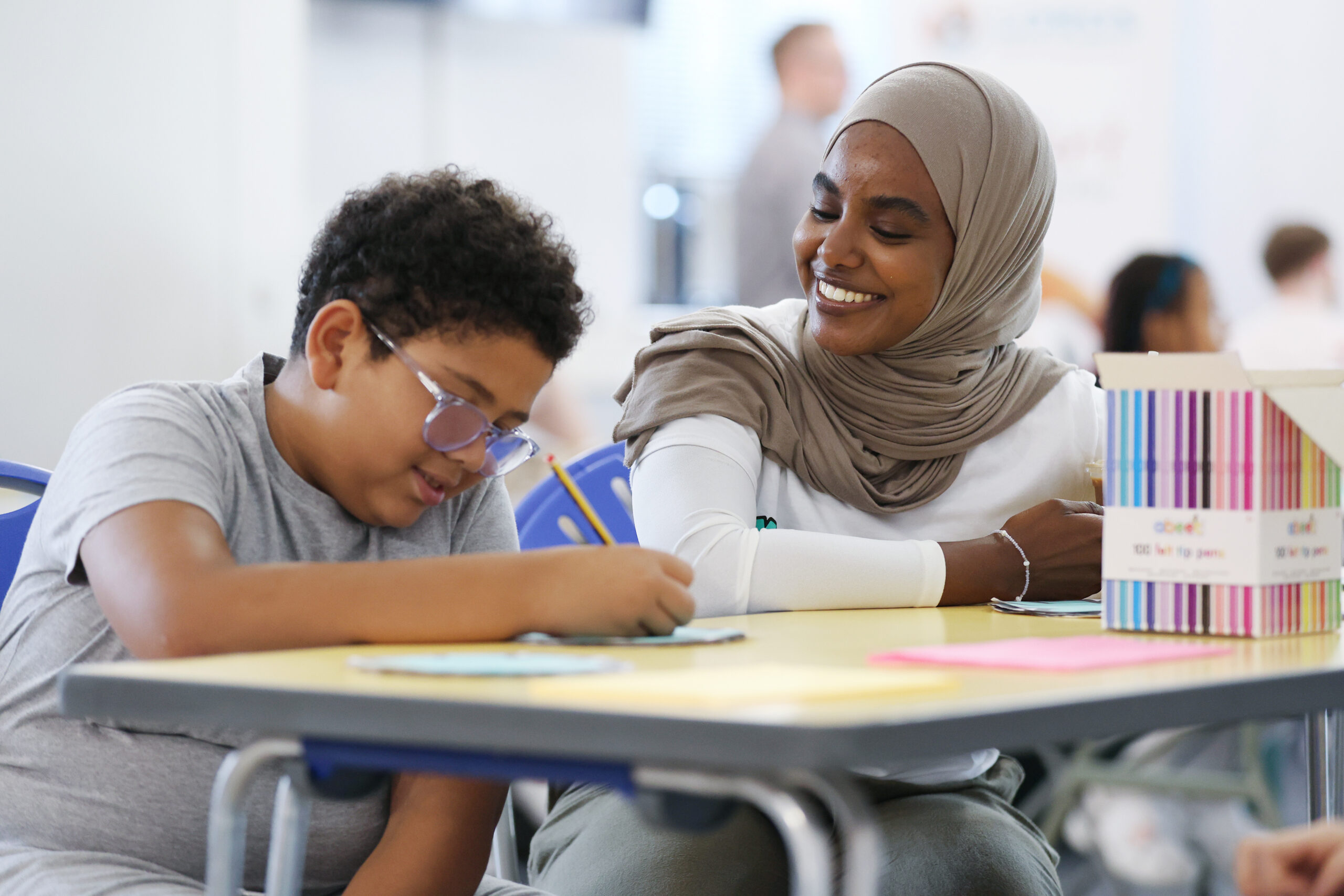 child and link worker working together in school