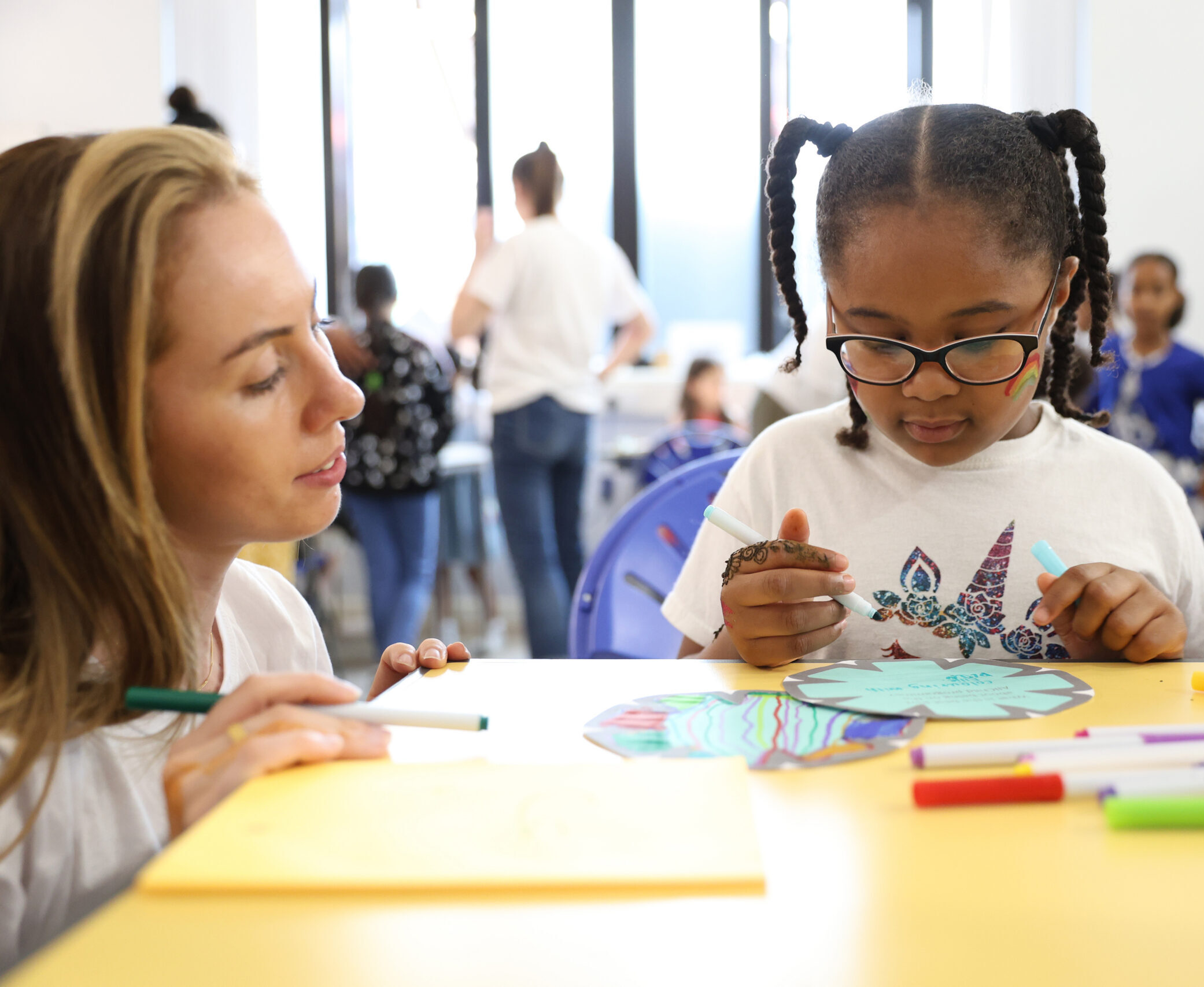 female link worker and primary school child in classroom
