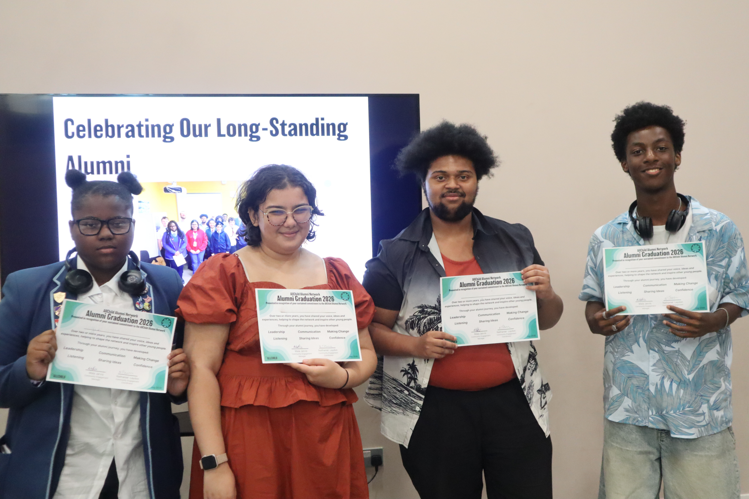Photo of four alumni with certificates at the Alumni Showcase 2026