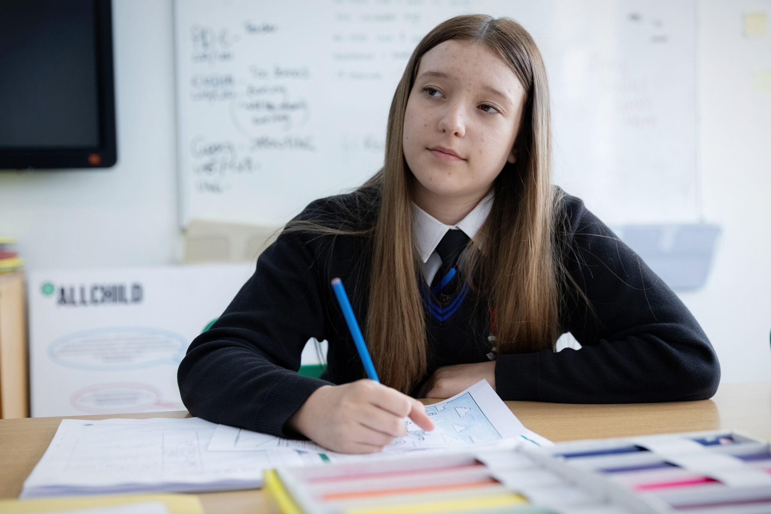 Schoolchild sat at table in Wigan classroom